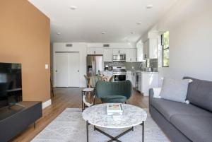 a living room with a couch and a table at Mid-Wilshire 2br w roof terrace nr shopping LAX-1121 in Los Angeles