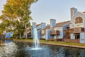 a fountain in a canal in front of condos at Foster City 2br w gym pool wd nr shops SFO-1293 in Belmont