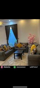 a living room with two couches and a table at استراحة العالمية alalamia resort in Taif