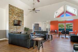 a living room with leather furniture and a brick wall at Foster City 2BR w Gym 2 Pools WD nr VISA SFO-969 in Foster City