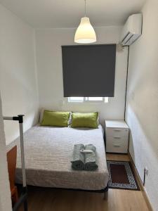 um pequeno quarto com uma cama com um grande ecrã em El Gengo Hostel em Madri
