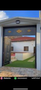 a view of a house through a door at استراحة العالمية alalamia resort in Taif