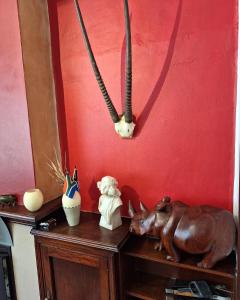 a shelf with a statue of a rhino on it at Clarence House in Cape Town