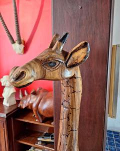 a wooden head of a deer on top of a shelf at Clarence House in Cape Town