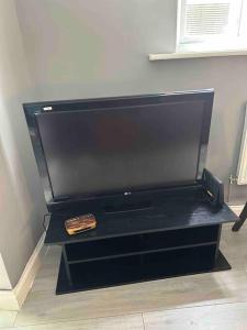 a large flat screen tv sitting in a room at Central London - Edgware Road 2 GF Bedroom Flat in London