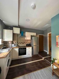 a kitchen with white cabinets and a dishwasher at Central London - Edgware Road 2 GF Bedroom Flat in London