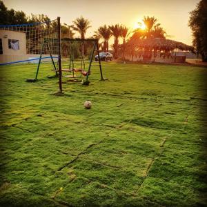 a soccer ball sitting on a field with a goal at مزرعة الفهد in Al Ḩazm