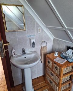 a bathroom with a sink and a mirror at Clarence House in Cape Town