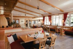 a restaurant with a table and chairs and a bar at Landhotel Endhart in Landsberg am Lech