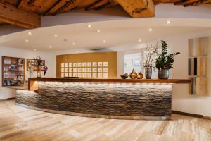 a bar in a room with a stone wall at Relax- & Wanderhotel Poppengut in Hinterstoder