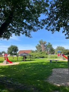 un parque con parque infantil y columpio en Ferienwohnungen im Teichland Linum, en Linum