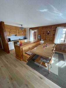 a kitchen with a wooden table in a kitchen with a tableablish at Appartement - Villars Sur Ollon in Villars-sur-Ollon