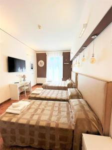 Postel nebo postele na pokoji v ubytování Hotel Alinari