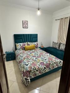 a bedroom with a bed and a couch in it at Appartement à beni mellal in Beni Mellal