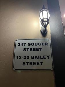 a street sign with a light on a wall at city ex hotel ensuite room in city 408 in Adelaide