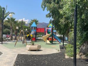 a playground with a slide in a park at Casa Vacanza Mauricio in Falcone