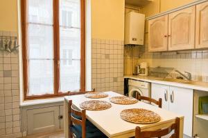 a kitchen with a table with three plates on it at Marx Residence T2 4 personnes - Wifi #EA in Grenoble