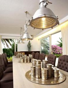 a dining room with a table with silver containers on it at Villa Peljesac Majestic A Beautiful 8 Bedroom Villa Short Stroll Down the Path to the Beach in Orebić