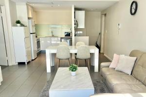 a living room with a couch and a table at Charming One-Bed Apt in the Heart of Parramatta in Sydney