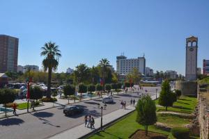 a city street with a clock tower in the distance at Rezidenca SHOPI Apartments in Elbasan