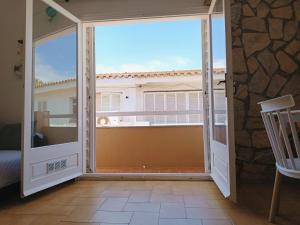 an open door to a balcony with a view at Costa brava apartment, Estartit in Torroella de Montgrí