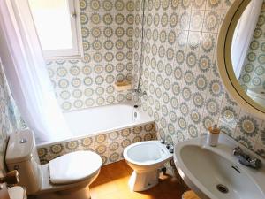 a bathroom with a toilet and a sink and a mirror at Costa brava apartment, Estartit in Torroella de Montgrí
