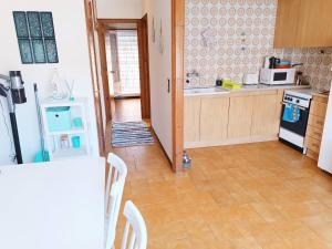 a kitchen with a stove and a refrigerator and a table at Costa brava apartment, Estartit in Torroella de Montgrí +5 photos