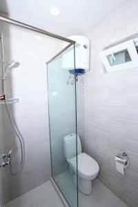 a bathroom with a toilet and a glass shower at Sweet Home 2 in Shekvetili in Shekvetili