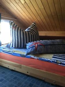 a bed in a room with a wooden ceiling at Ferienhaus Nele - a90930 in Kühlungsborn