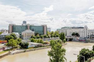 a view of a river in a city with buildings at Apartment Untere Donaustrasse in Vienna