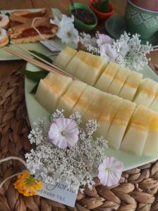 a plate of cheese and flowers on a table at B&B Badde Tale in Ossi