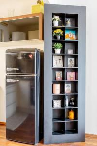 a kitchen with a refrigerator and shelves with plants at Apartment Untere Donaustrasse in Vienna