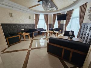 a large living room with couches and tables at Hotel Bohemi in Haskovo