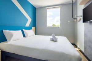 Postel nebo postele na pokoji v ubytování ibis budget Nanterre la Defense