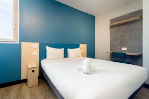 Postel nebo postele na pokoji v ubytování ibis budget Nanterre la Defense