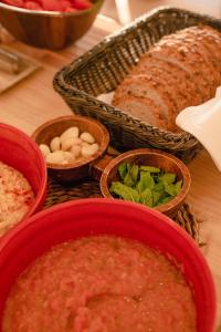 a table topped with bowls of soup and bread at Hotel Riomar, Ibiza, a Tribute Portfolio Hotel in Santa Eularia des Riu