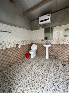 a bathroom with a toilet and a sink at SaPa Hmong Streamside Homestay in Sa Pa +47 photos