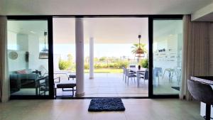 un soggiorno con porte in vetro e una sala da pranzo di AA Guest - Luxury Paradise Eco Apartment Higueron a Fuengirola