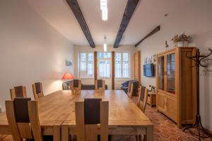 a dining room with a large wooden table and chairs at Gite des Gargouilles in Saint-Valéry-sur-Somme