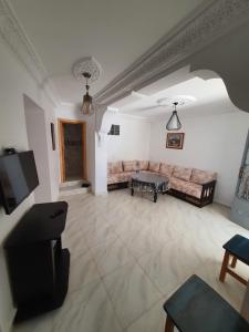 a living room with a couch and a table at aline hostel 2 in Chefchaouen