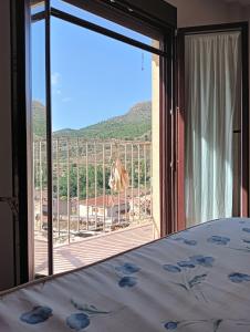 a bedroom with a bed and a view of a balcony at La cerrada in El Collado