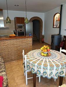 a kitchen with a table with a bowl of fruit on it at La cerrada in El Collado
