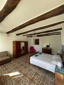 a bedroom with a bed and a couch in a room at Casa Vacanze Nonna Sissi in Maratea