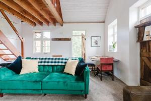 a living room with a green couch and a table at Wye Riverside Lodge in Llandrindod Wells