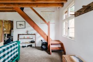 a living room with a staircase in a house at Wye Riverside Lodge in Llandrindod Wells