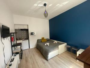 a bedroom with a large bed with a blue wall at Direct access to Paris & the Champs-Elysees in Asnières-sur-Seine