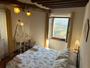 une petite chambre avec un lit et une fenêtre dans l'établissement La Casa di Laura, à Cortone