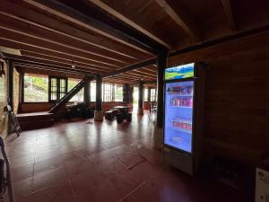 a living room with a large screen television in a building at SaPa Hmong Streamside Homestay in Sapa