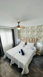 a bedroom with two beds with white sheets at Bajondillo Beach Cozy Inns in Torremolinos