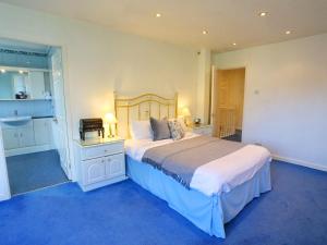 a bedroom with a large bed and a bathroom at Pass the Keys Family Home With Parking Next To Heaton Park in Manchester